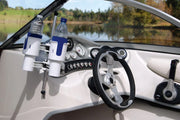 Boat interior with a RoboCup drink holder and steering wheel, featuring a scenic lake view outside.