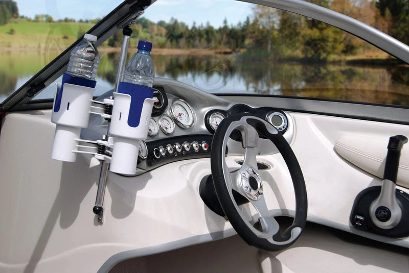Boat interior with a RoboCup drink holder and steering wheel, featuring a scenic lake view outside.