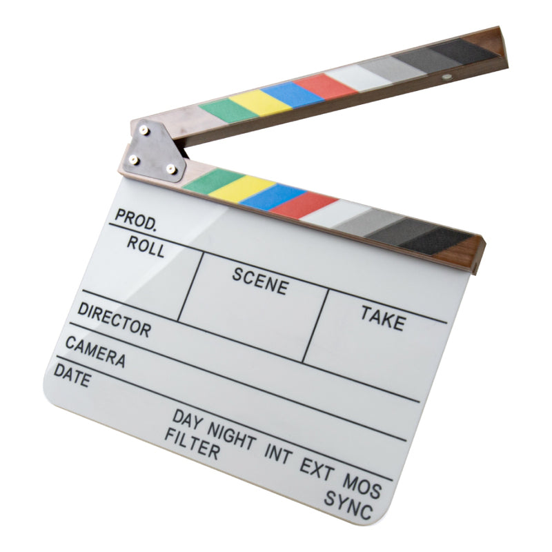 A professional film clapperboard with a white writing surface, black text fields, and a striped hinged top featuring a rainbow of color blocks (green, yellow, red, blue, white, gray, black) and a brown wood-grain finish, isolated on a white background.