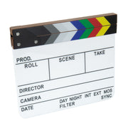 A classic film clapperboard with a white writing surface, black text fields, and a hinged wooden clapper top featuring the color stripes of black, gray, white, green, red, and yellow. The board is shown isolated on a solid white background.